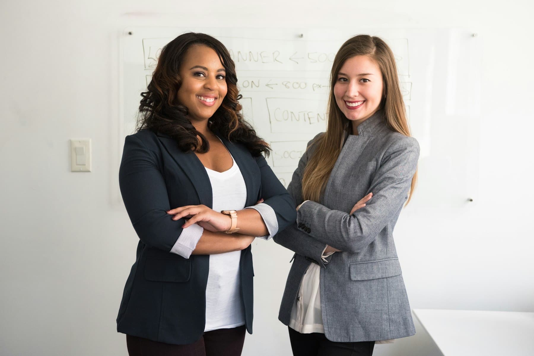 Two professionals standing together in an office
